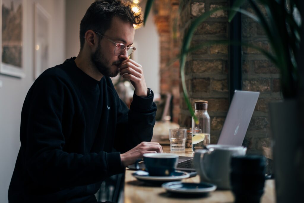 A man considering what web address he should use for his business.