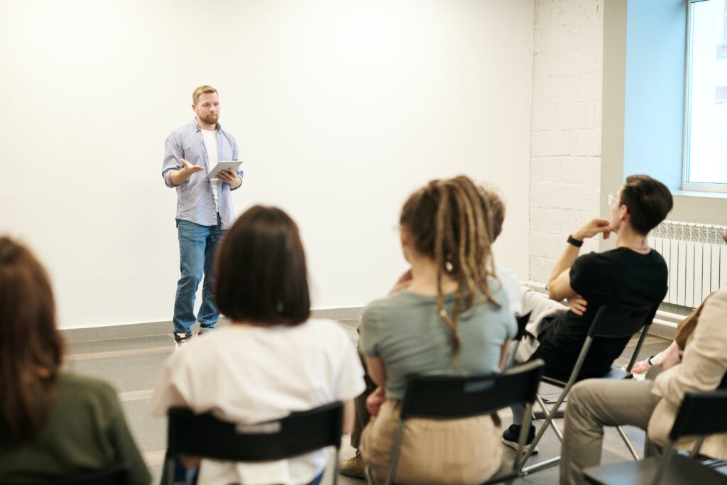 Man talking to an audience of potential customers.