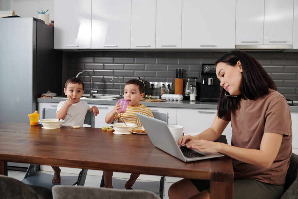 A mom on the phone scheduling a home service appointment.