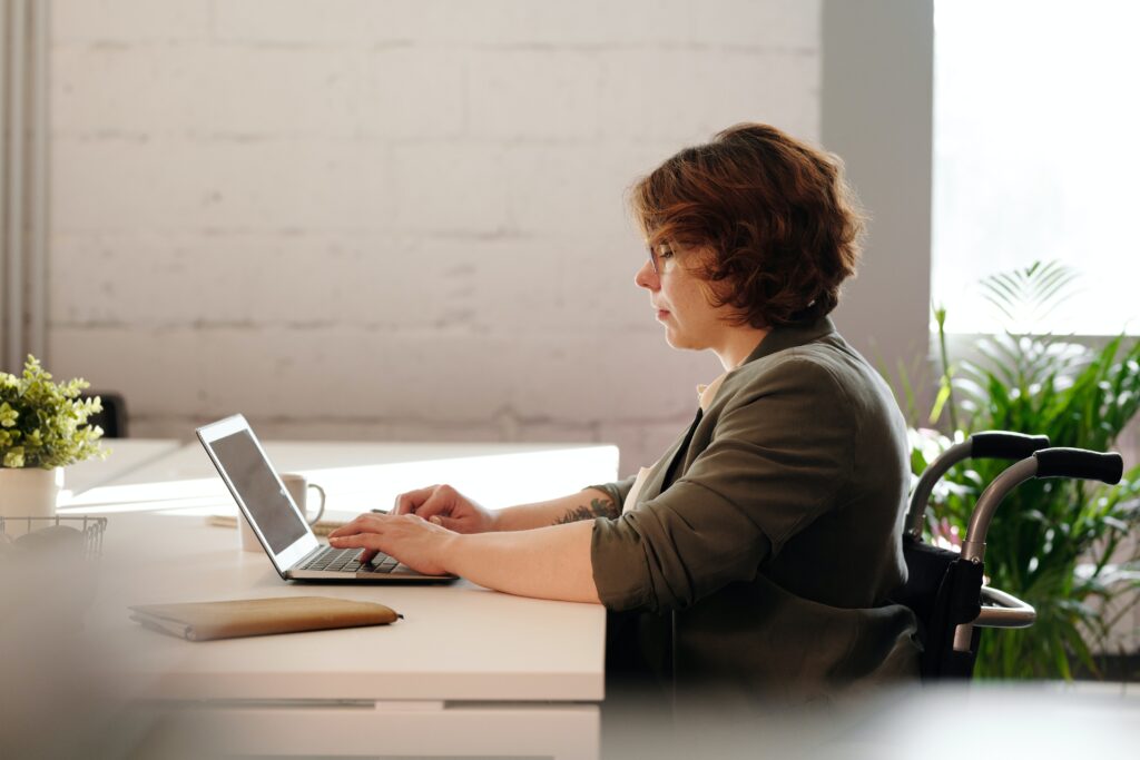 Woman in a wheelchair working on improving her website speed.