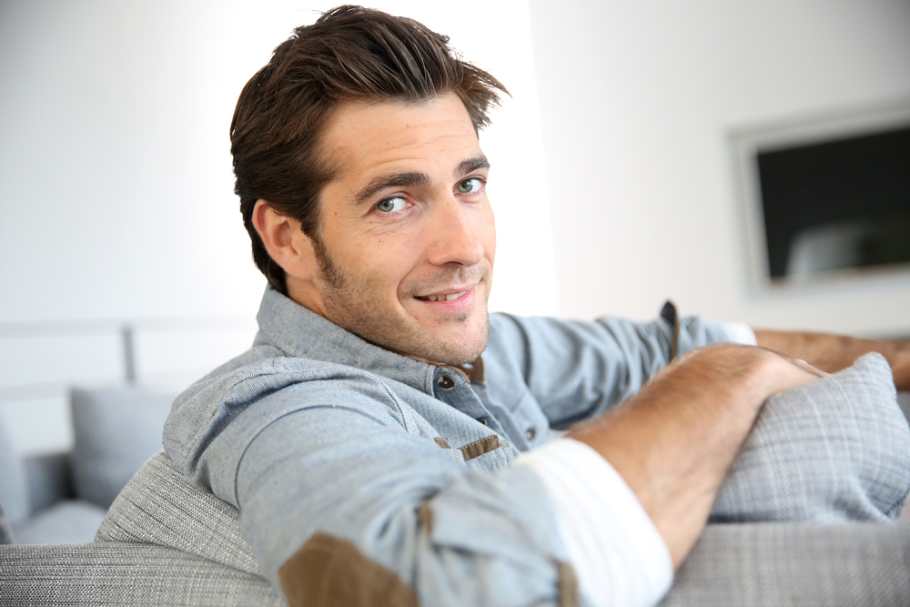 Man at home sitting in front of tv set